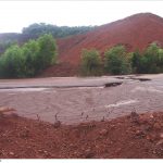 Mining dump behind parched mud